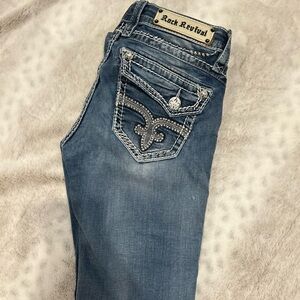 Rock Revival Women's Faded Blue Jeans with Embellished Pockets